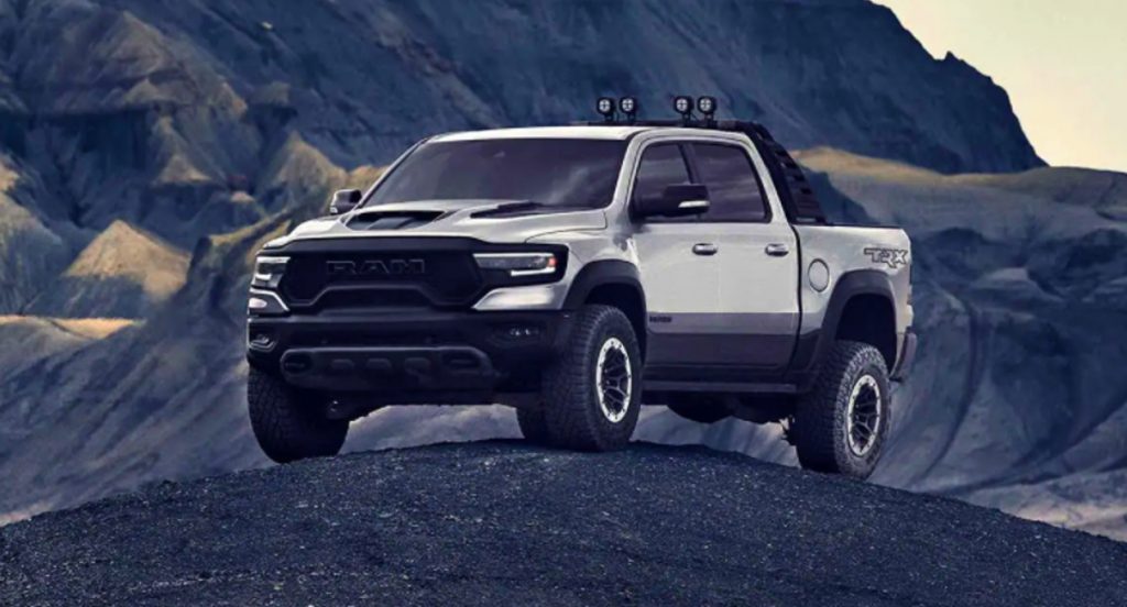 A silver Ram 1500 TRX is parked on a hill. 