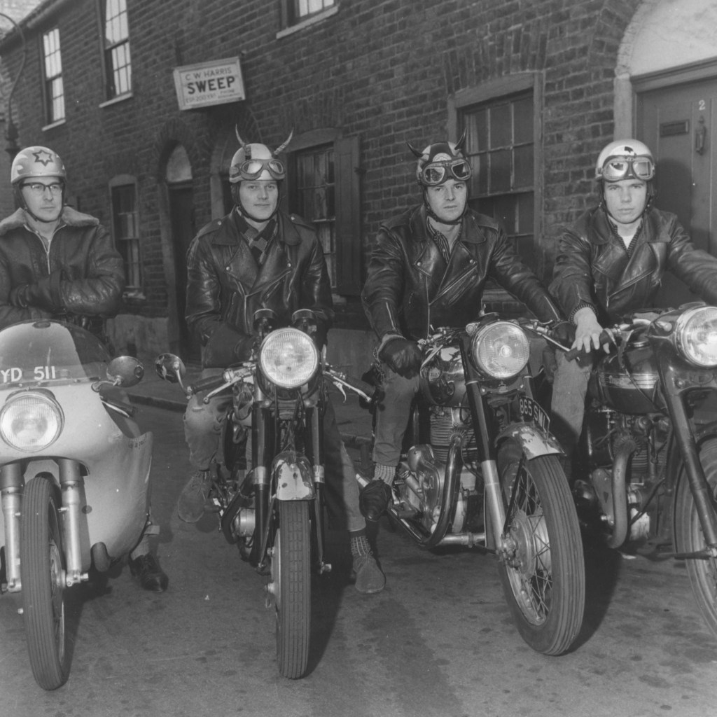Ton-up boys on their cafe racers in 1960 in an alleyway