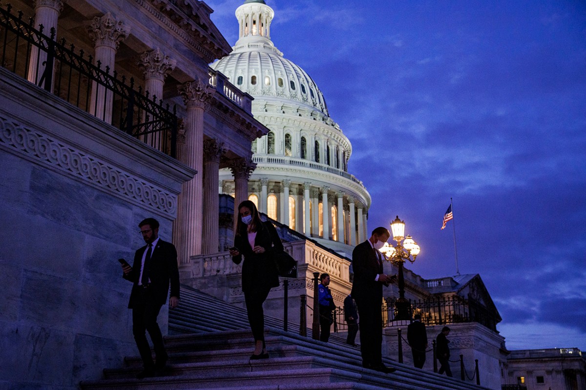 The United States Capitol building shot at night from a low angle