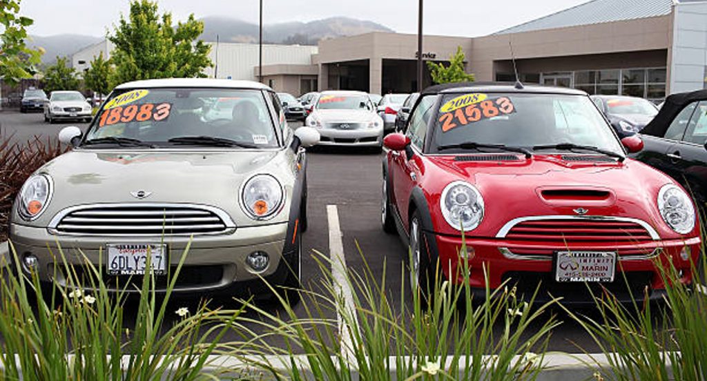 Used cars are displayed on a sales lot .