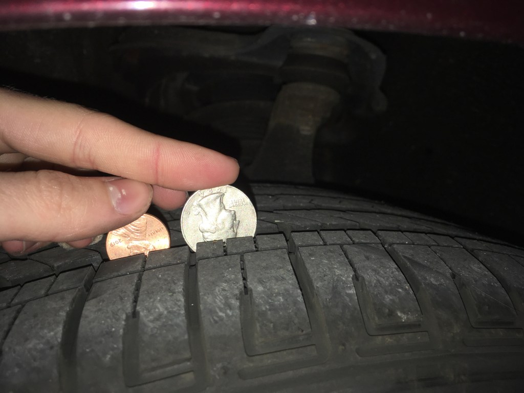 Using a quarter and a penny to test the tread depth of a tire