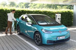 The Volkswagen ID.3 electric compact hatchback car EV with a mint green color option parked at a charging station