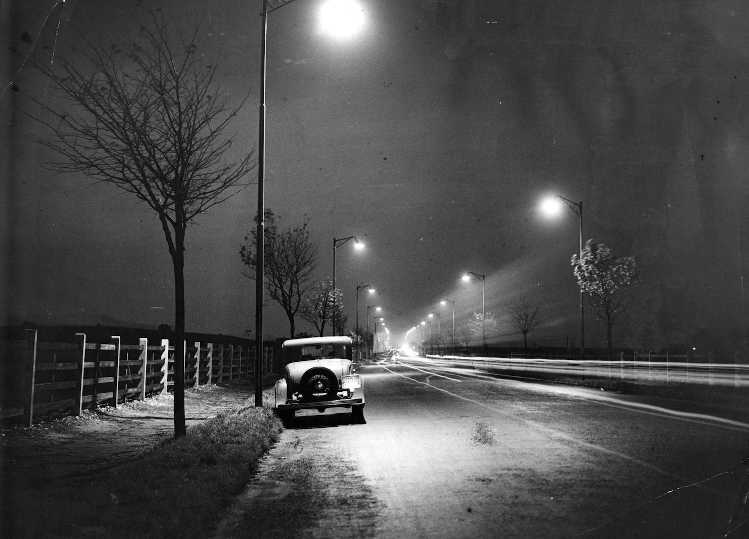 A car parked on a deserted road at night. Finding parking is one reason Why You’ll Regret Living in a Car Full Time. | Keystone/Getty Images