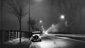 A car parked on a deserted road at night. Finding parking is one reason Why You’ll Regret Living in a Car Full Time. | Keystone/Getty Images