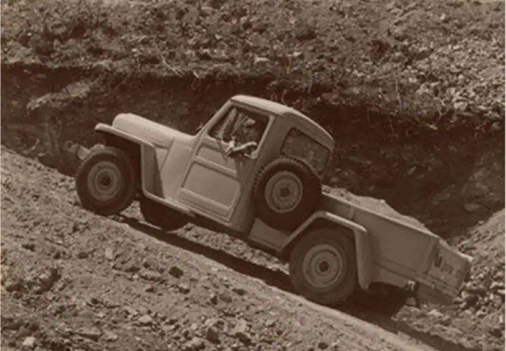 A Willys-Overland Truck climbs a rocky dirt hill