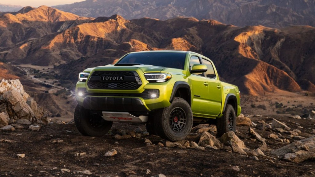 Electric Lime green 2022 Toyota Tacoma pickup truck with mountains in the background