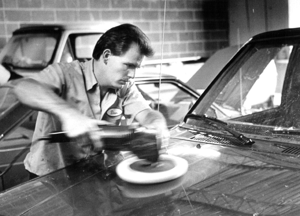 Dan Gregg is buffing out a car that he is detailing they also do repair work.