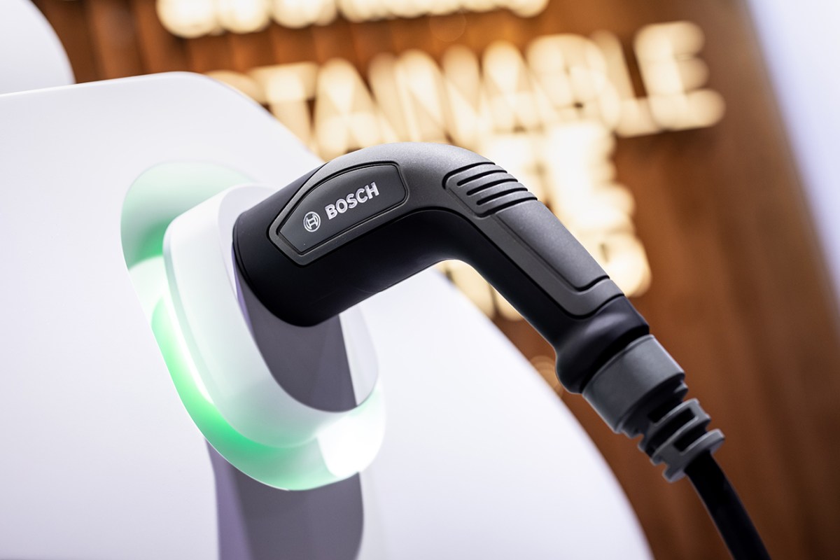 A charging plug with the inscription "Bosch" is inserted into a model of an electric vehicle at the Bosch booth during the International Motor Show. International governments are speaking out against the recently proposed U.S EV tax credits