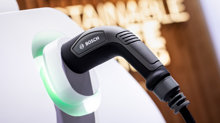 A charging plug with the inscription "Bosch" is inserted into a model of an electric vehicle at the Bosch booth during the International Motor Show. International governments are speaking out against the recently proposed U.S EV tax credits