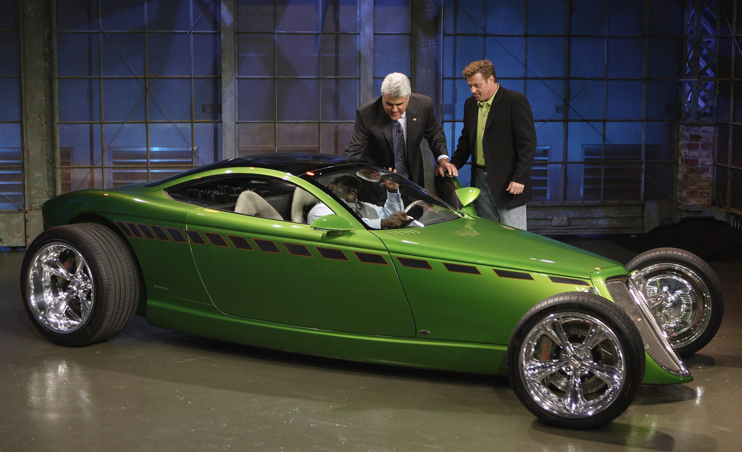 Chip Foose and Jay Leno stand in front of a bright green Plymouth Prowler concept on The Tonight Show