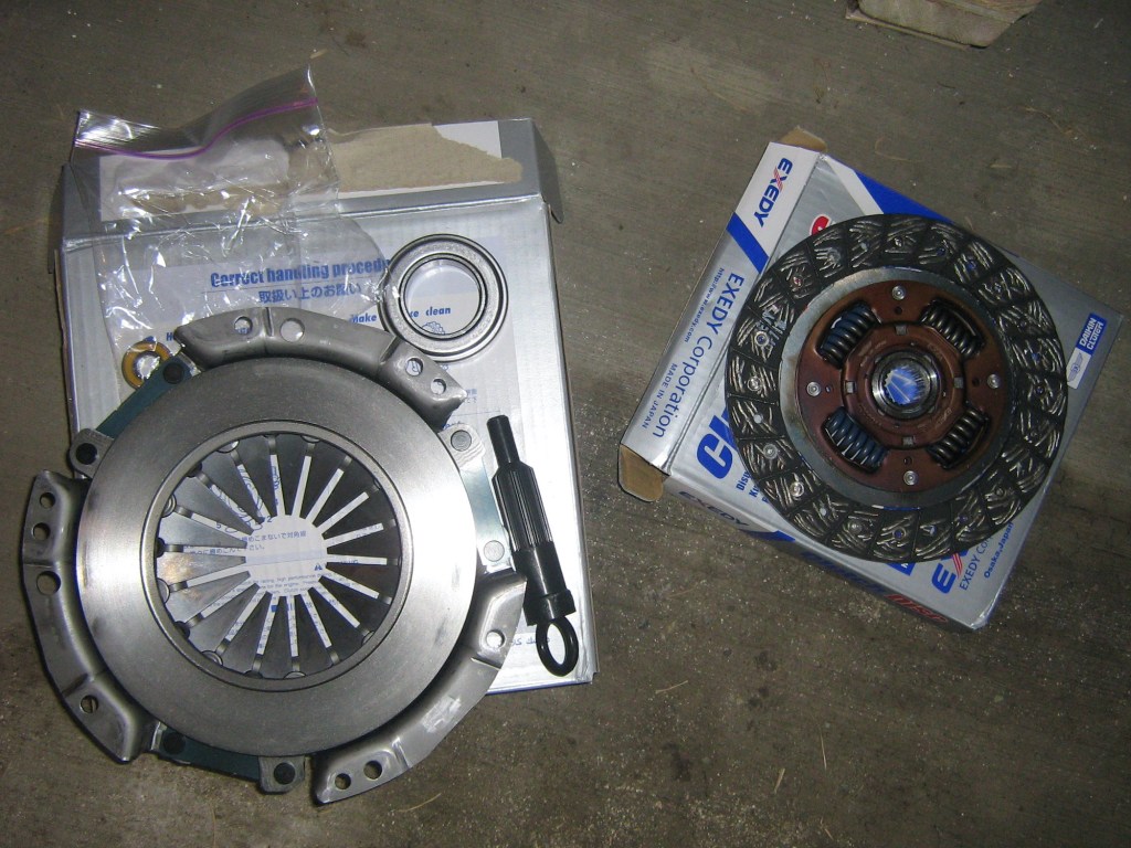 An Exedy clutch kit sitting on a garage floor