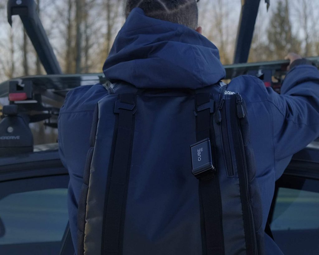 Cube GPS unit attached to a backpack strap