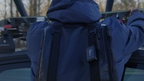 A Cube GPS unit attached to a man's backpack