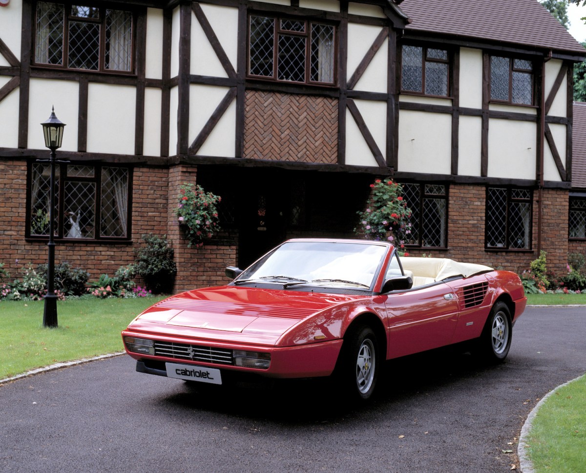 1987 Ferrari Mondial 3.2 cabriolet parked outside of a house