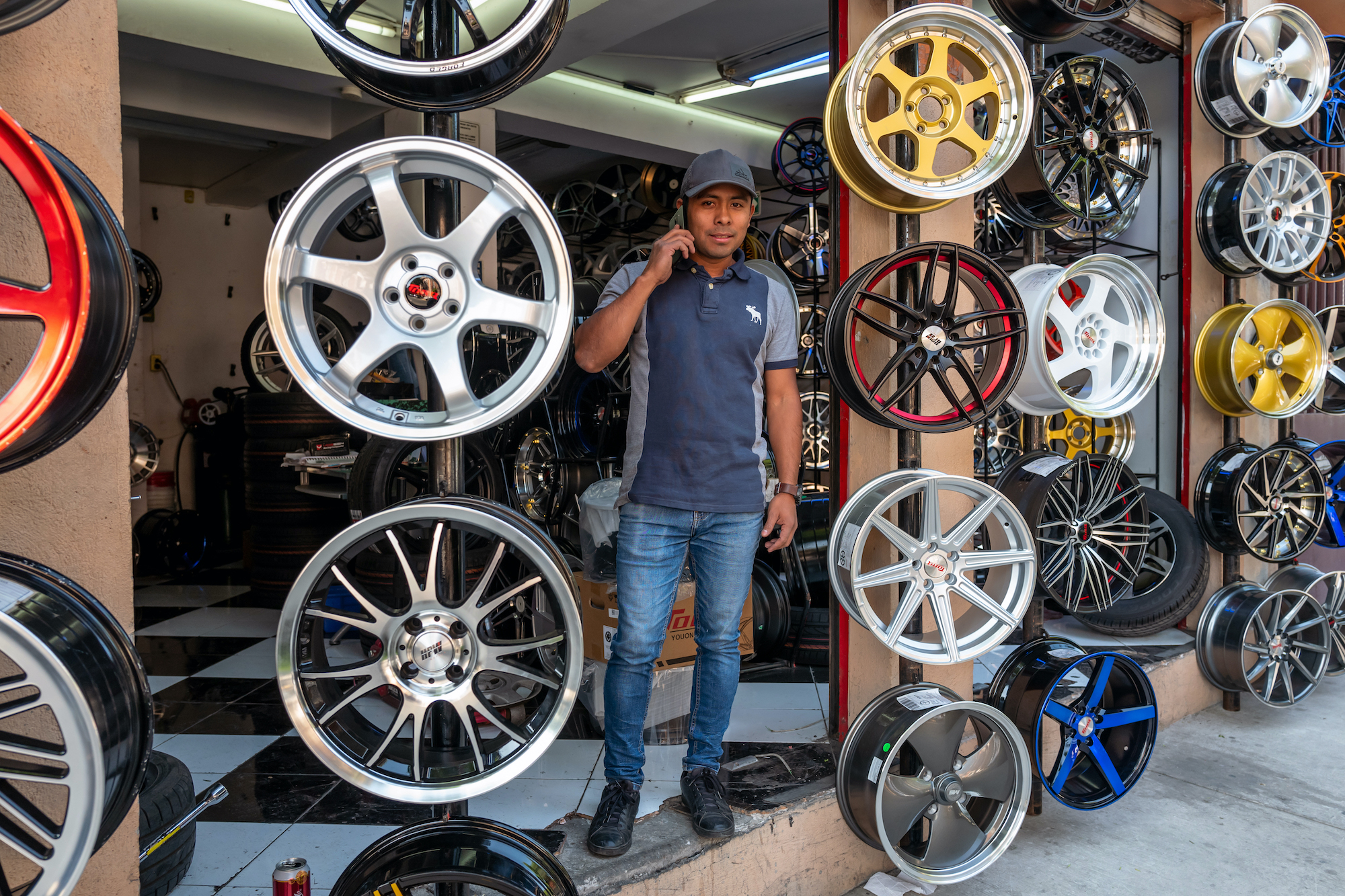 a man sell a bunch of wheels on a stand