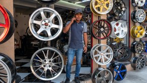 a man sell a bunch of wheels on a stand
