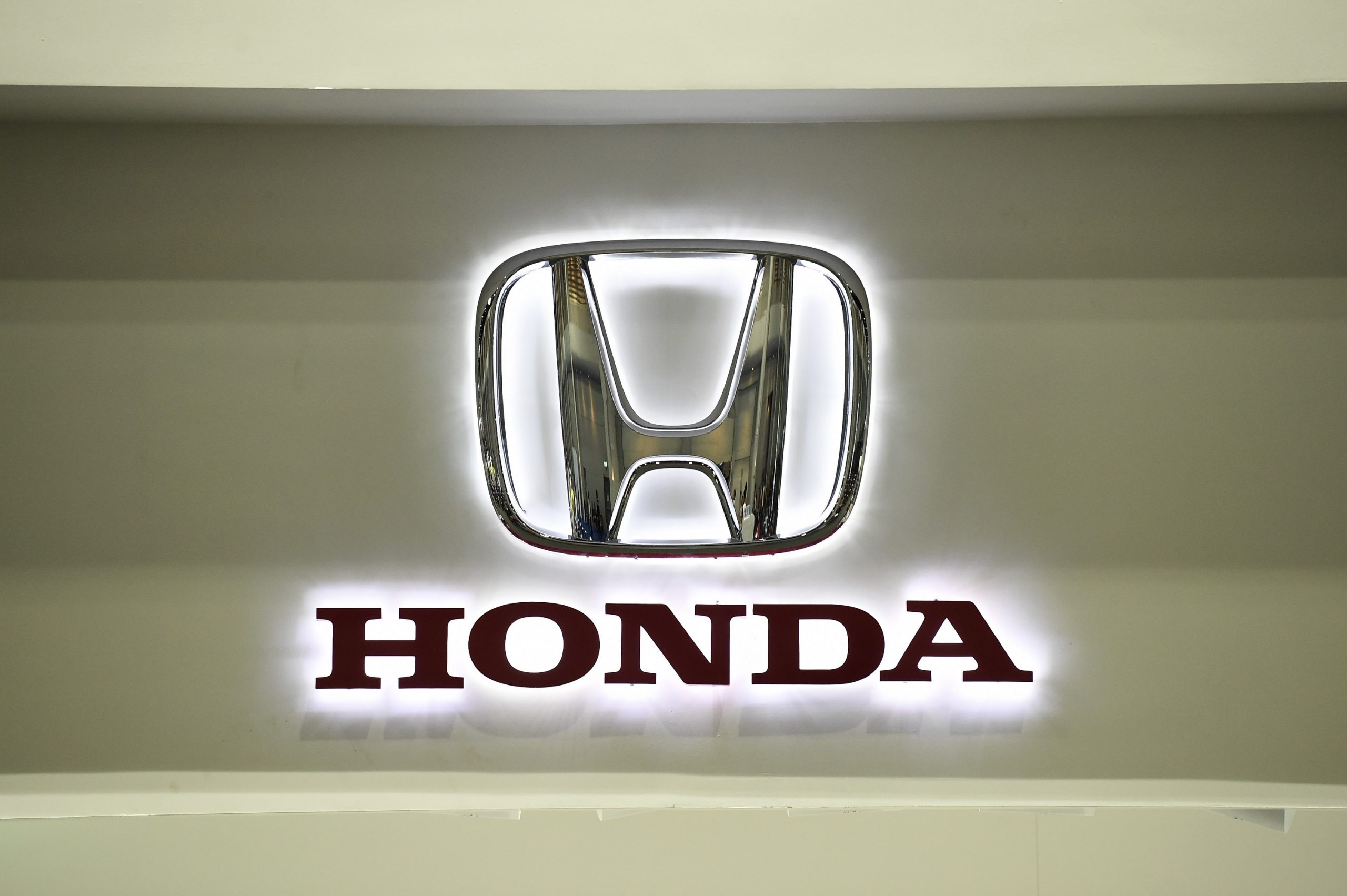 Honda, makers of some of the best new cars, displays their backlit silver logo at an auto show