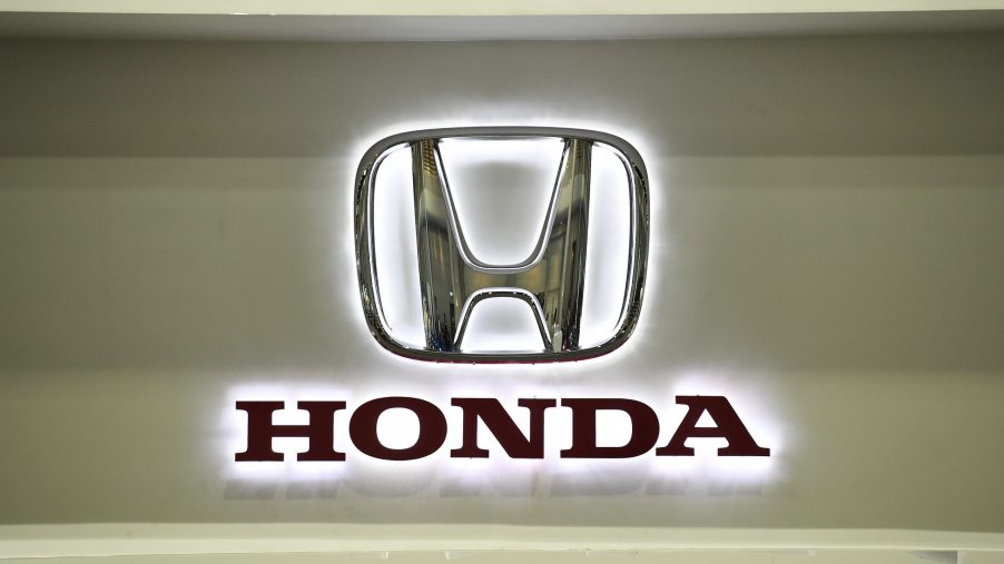 Honda, makers of some of the best new cars, displays their backlit silver logo at an auto show