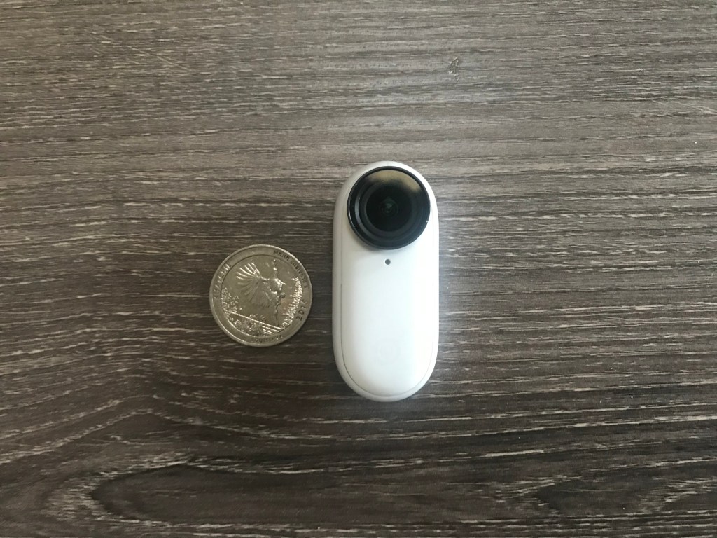The Insta360 Go 2 Camera next to a quarter to show size