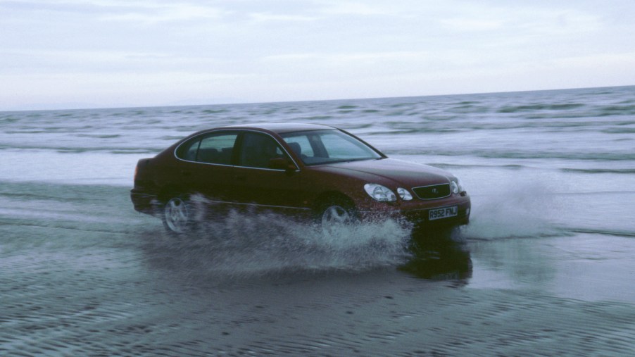 1999 Lexus GS300 driving through sea at Pendine sands, Wales