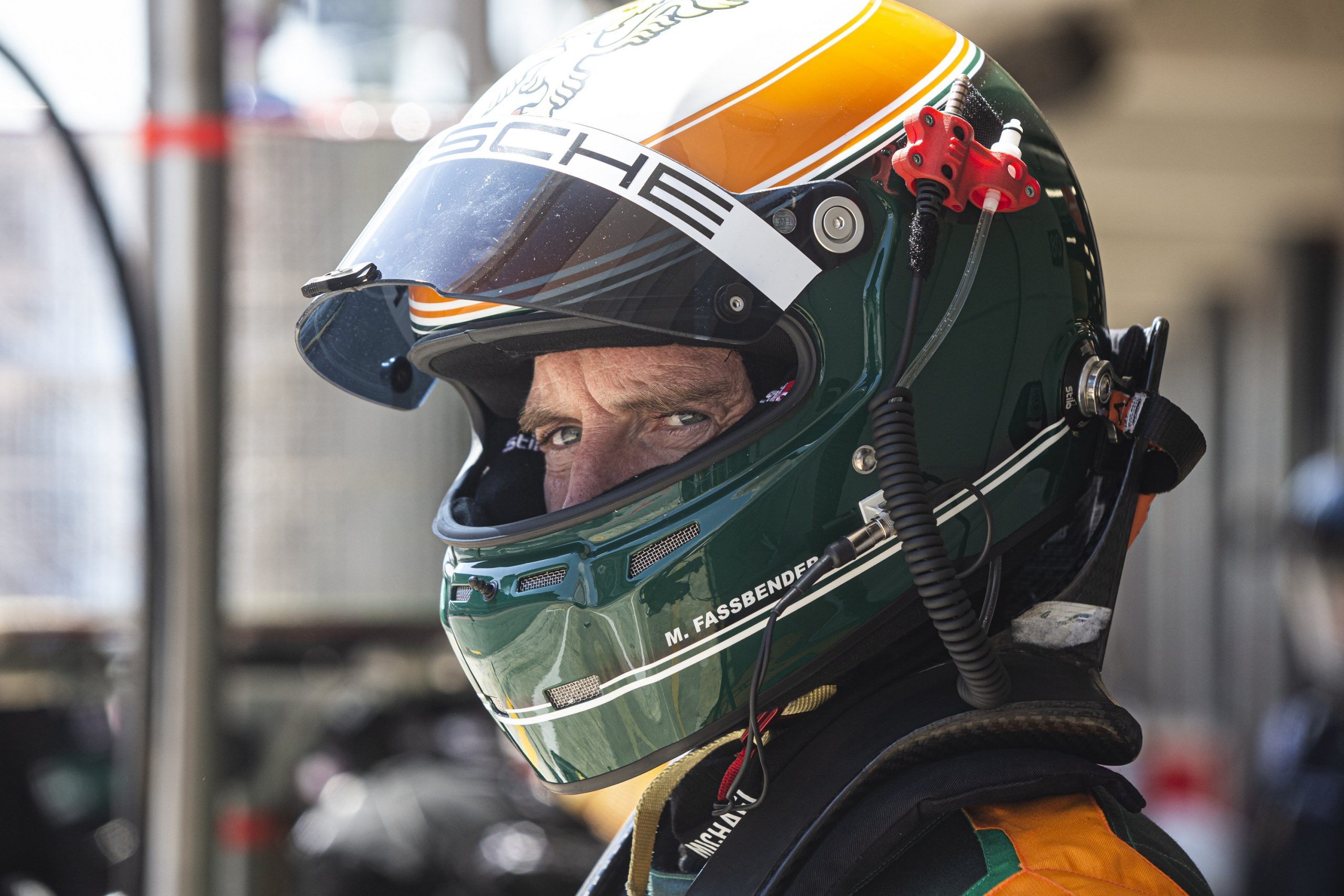 Michael Fassbender in a green and yellow race helmet during a practice session in Barcelona