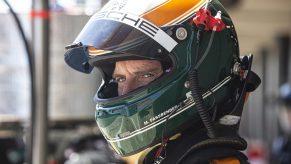 Michael Fassbender in a green and yellow race helmet during a practice session in Barcelona