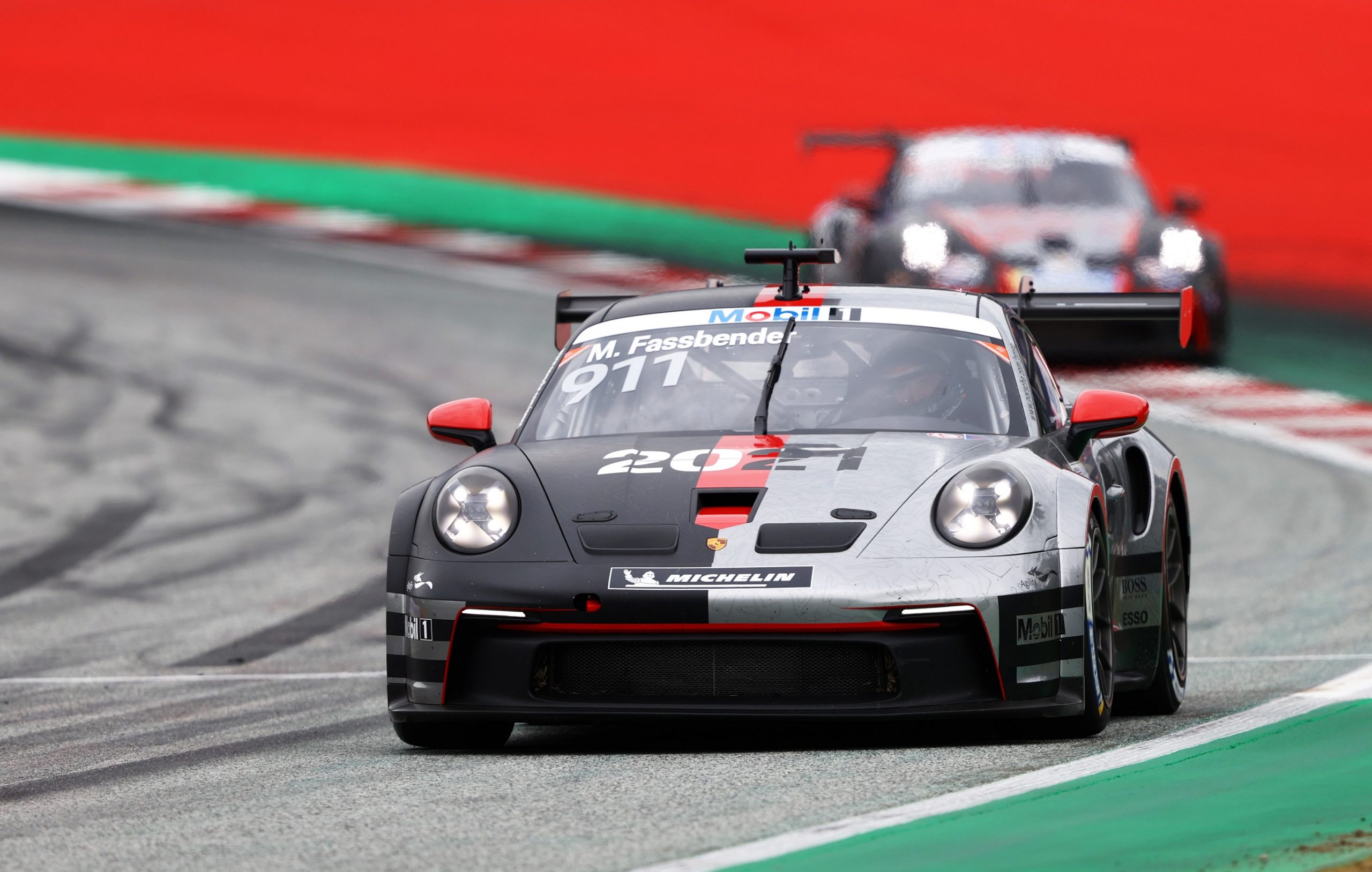Michael Fassbender's grey and red 24 Hours of Le Mans Porsche 911 at the Red Bull ring in July