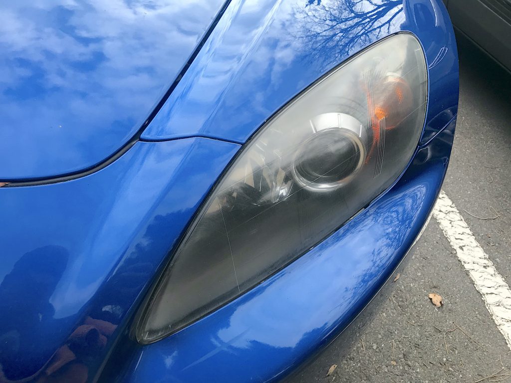 Here is what the headlight on my 2008 Honda S2000 looked like before the cleaning. You can see a little haze accumulated on it.