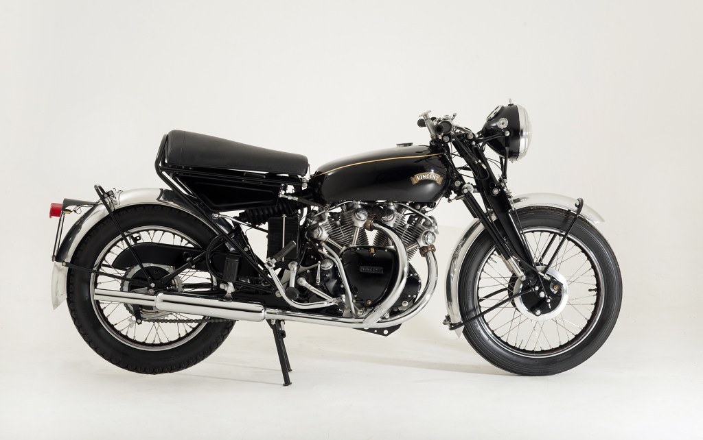The side view of a black 1955 Vincent Black Shadow in a white studio