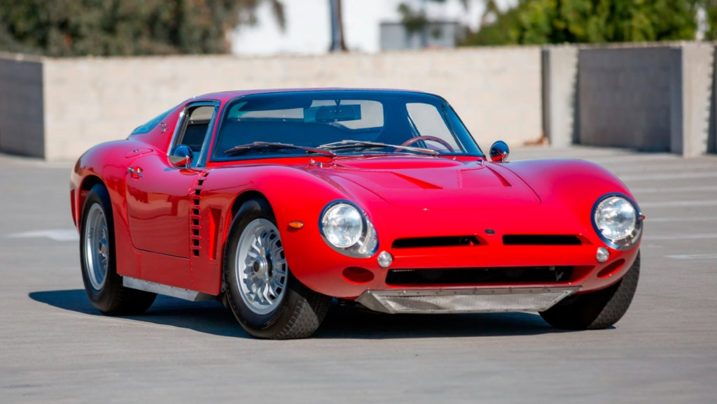 A red 1965 Iso Grifo A3/C in a parking lot