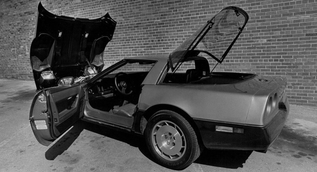 The rear 3/4 view of a 1986 Chevrolet C4 Corvette with its doors, hood, and trunk open