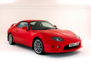 A 1997 Mitsubishi FTO GPX coupe sports car model with a red paint color option