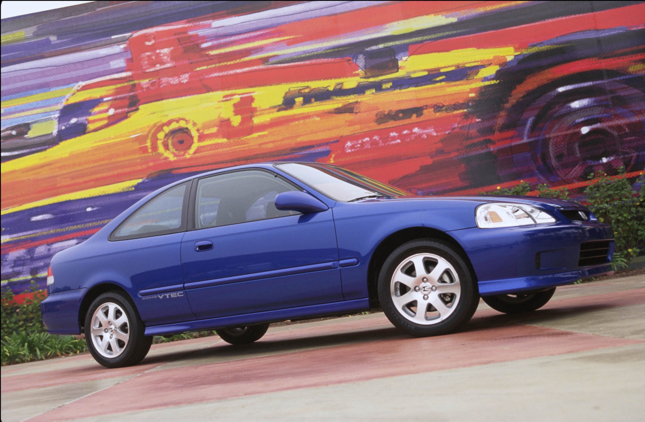 A blue EG series Civic Si shot in profile