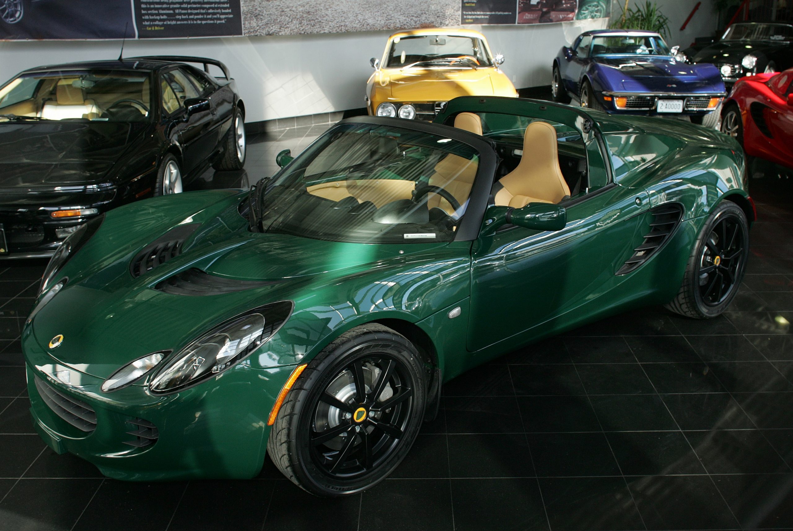 A green 2005 Lotus Elise in a car dealer