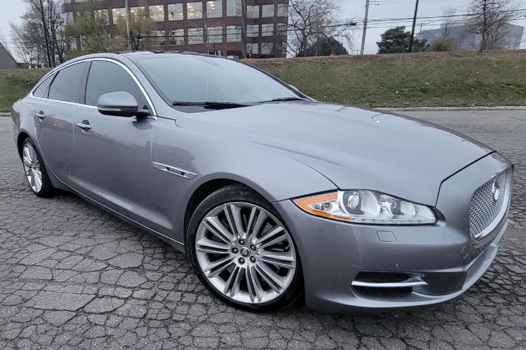 The front 3/4 view of a gray 2011 Jaguar XJ Supercharged in a parking lot