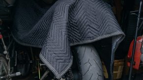 A 2012 Triumph Street Triple R motorcycle covered in winter storage