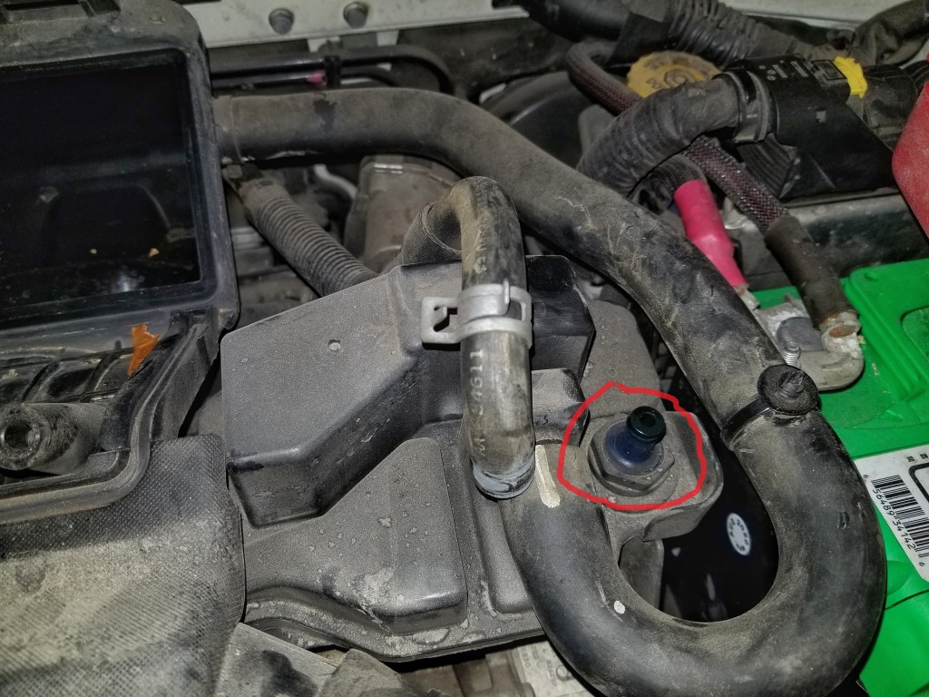 The oil separator of a 2013 Fiat 500 Abarth with the PCV valve highlighted in red