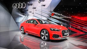 A red 2017 Audi RS5 sport sedan on display at the 2017 Geneva Motor Show in Switzerland