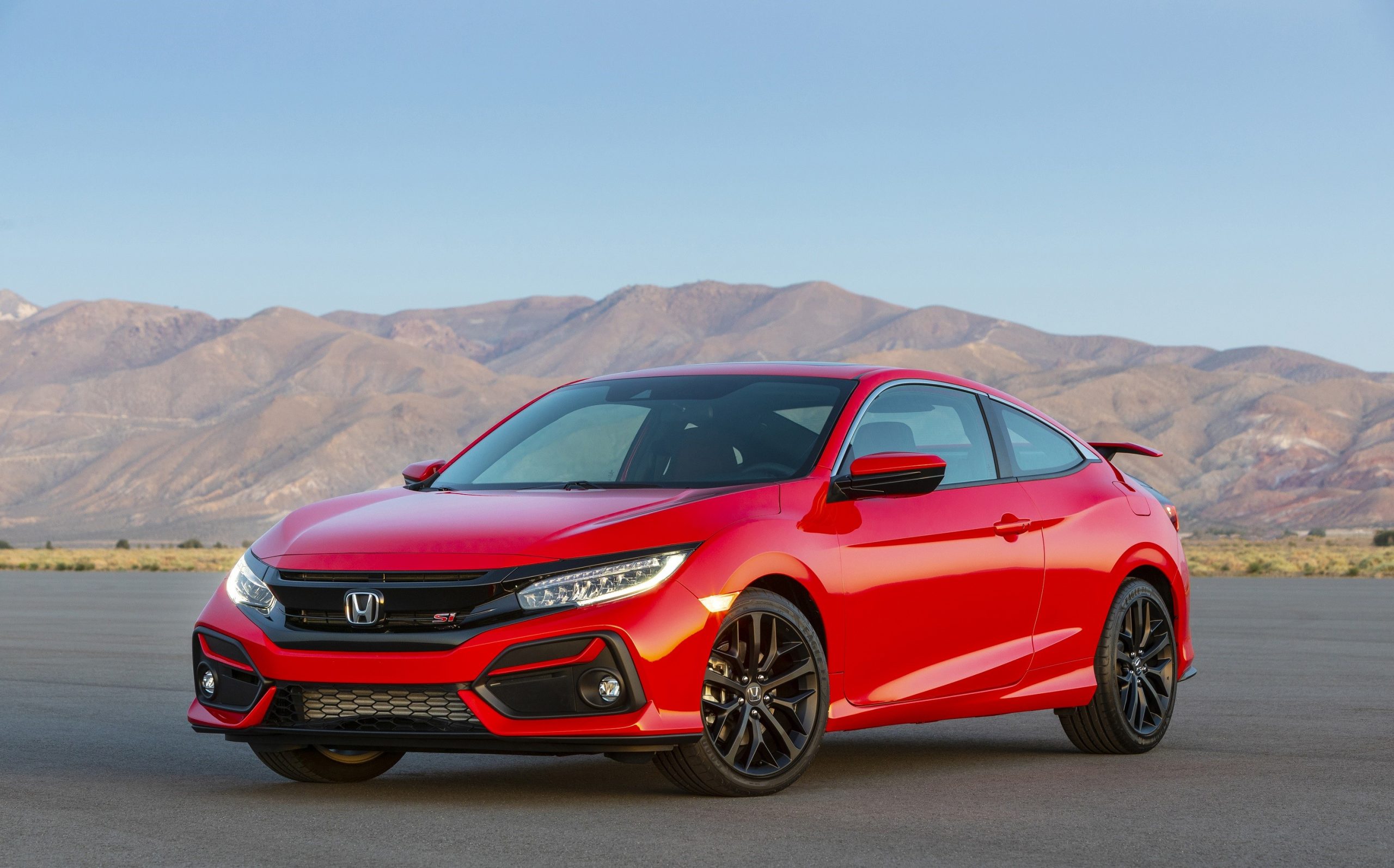 A red 2020 Honda Civic Si shot from the front 3/4