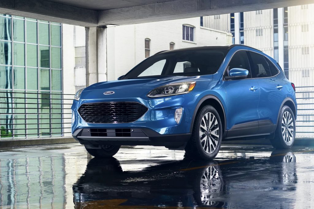 A blue 2021 Ford Escape parked indoors, it loses to the RAV4 in a lot of ways, according to U.S. News.