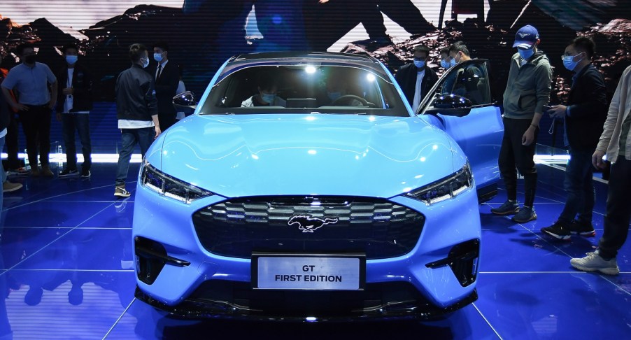 A blue 2021 Ford Mustang Mach-E is on display.