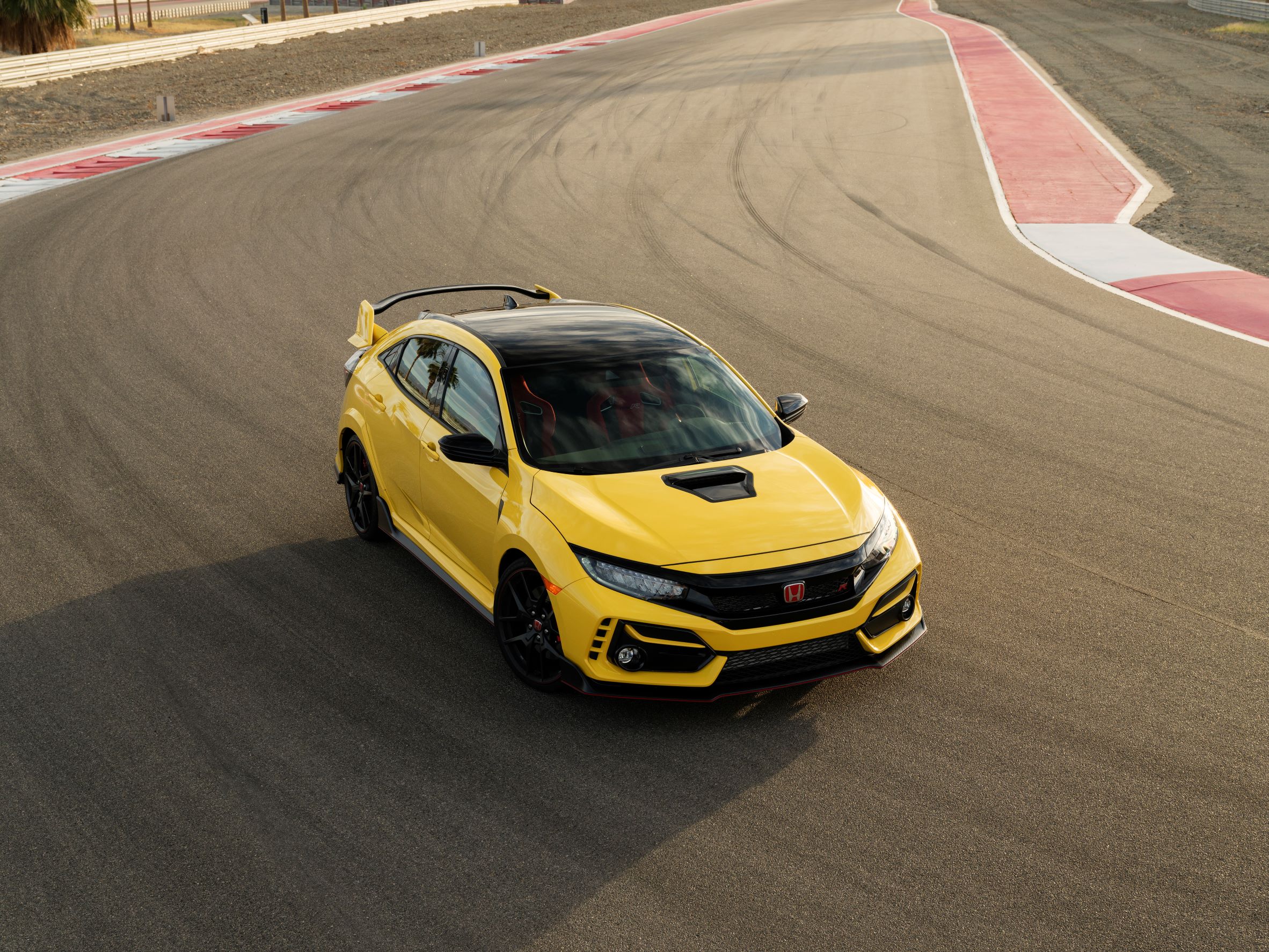 A yellow 2021 Honda Civic Type R with a manual transmission shot from the high 3/4 angle