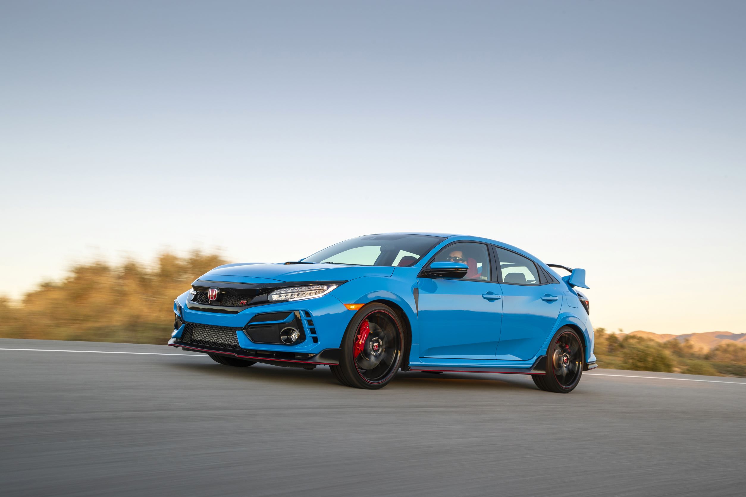 A blue 2021 Honda Civic Type R shot from the 3/4 angle at sunset