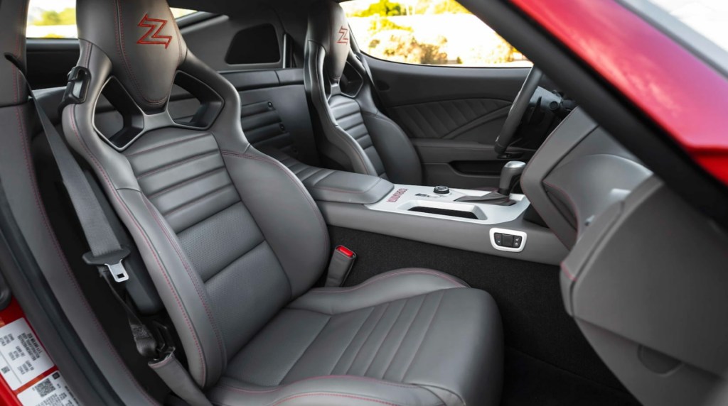 The black-with-red-stitching leather sport seats and dashboard of a red 2021 Iso Rivolta GT Zagato