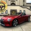 The 2021 Lexus LC 500 in front of a mausoleum with the MotorBiscuit logo