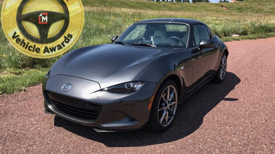 The 2021 Mazda MX-5-Miata in grey with our Car of the Year award Logo