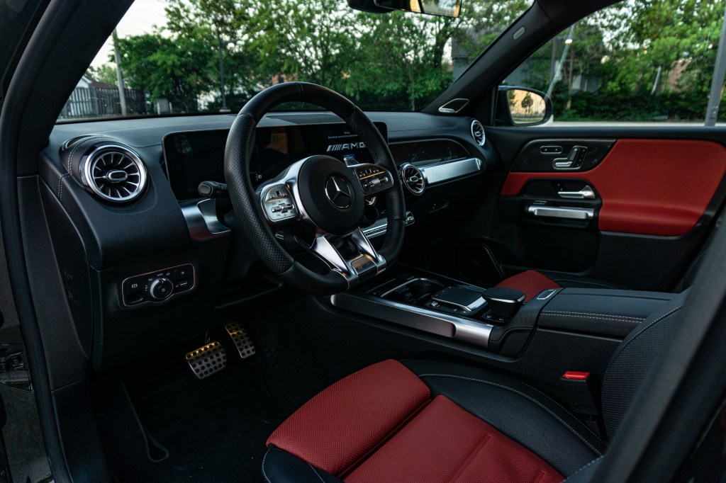 The side view of the red-and-black-leather front seats and black dashboard of a 2021 Mercedes-AMG GLB 35