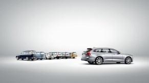 This is a publicity shot of the canceled 2021 Volvo V90 station wagon and its predecessors.