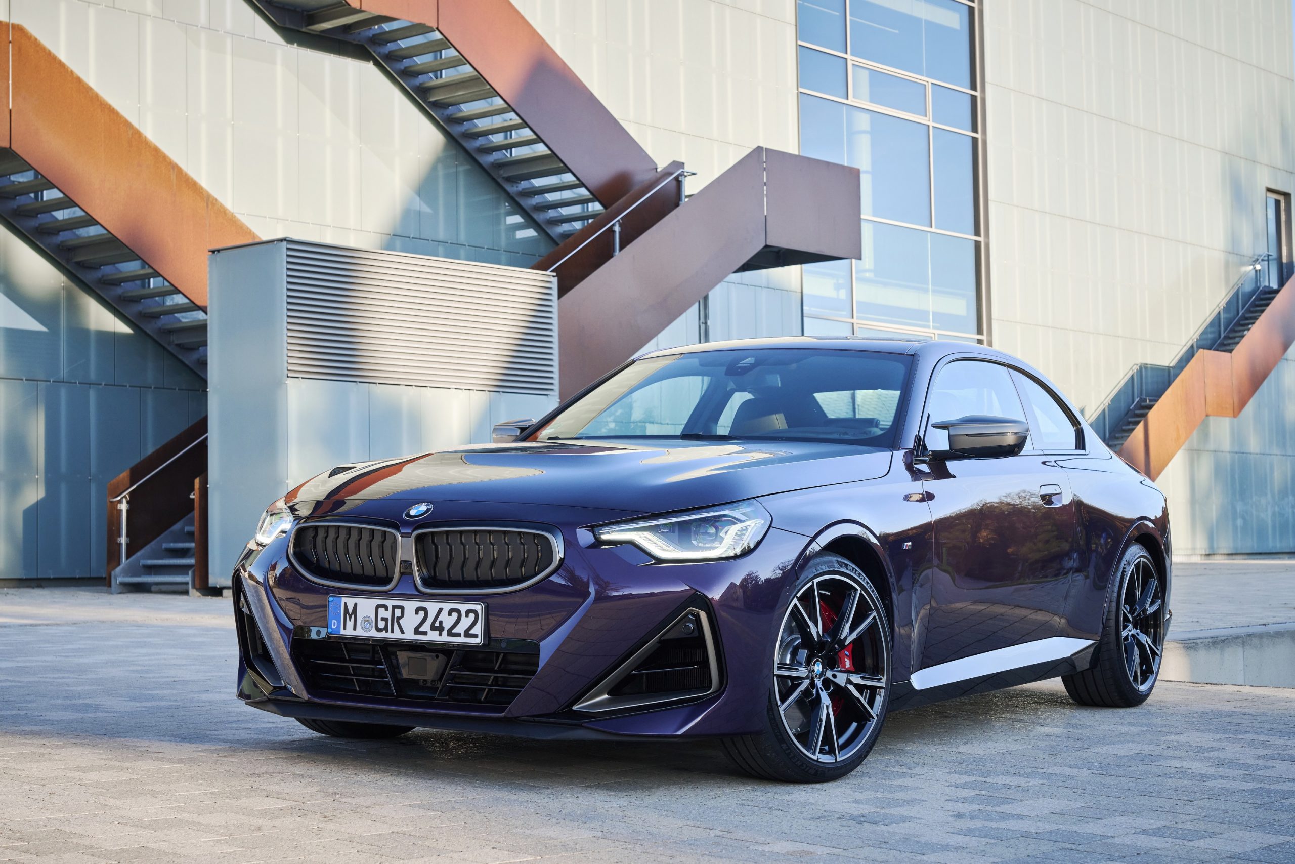 A purple BMW M240i sports car shot from the front 3/4