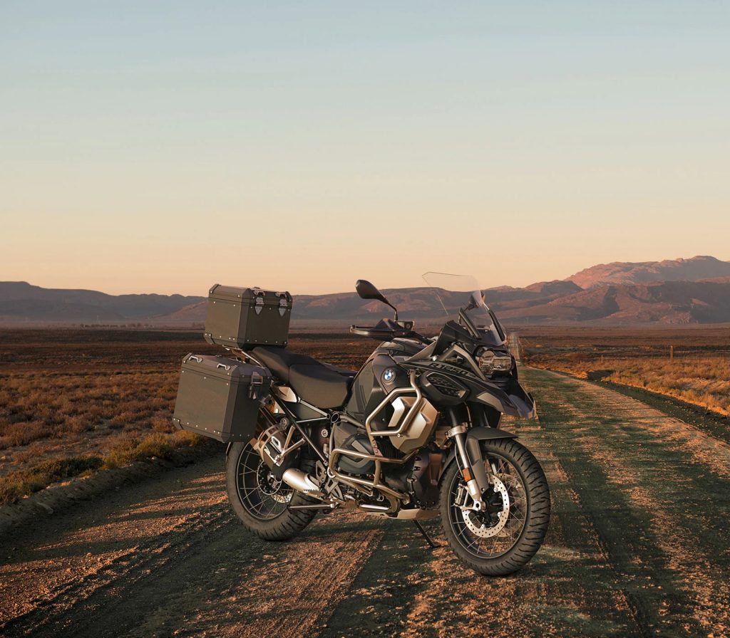 A black-and-silver 2022 BMW R 1250 GS Adventure with accessories on a desert road